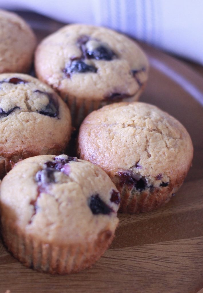 4 blueberry muffins on a brown plate