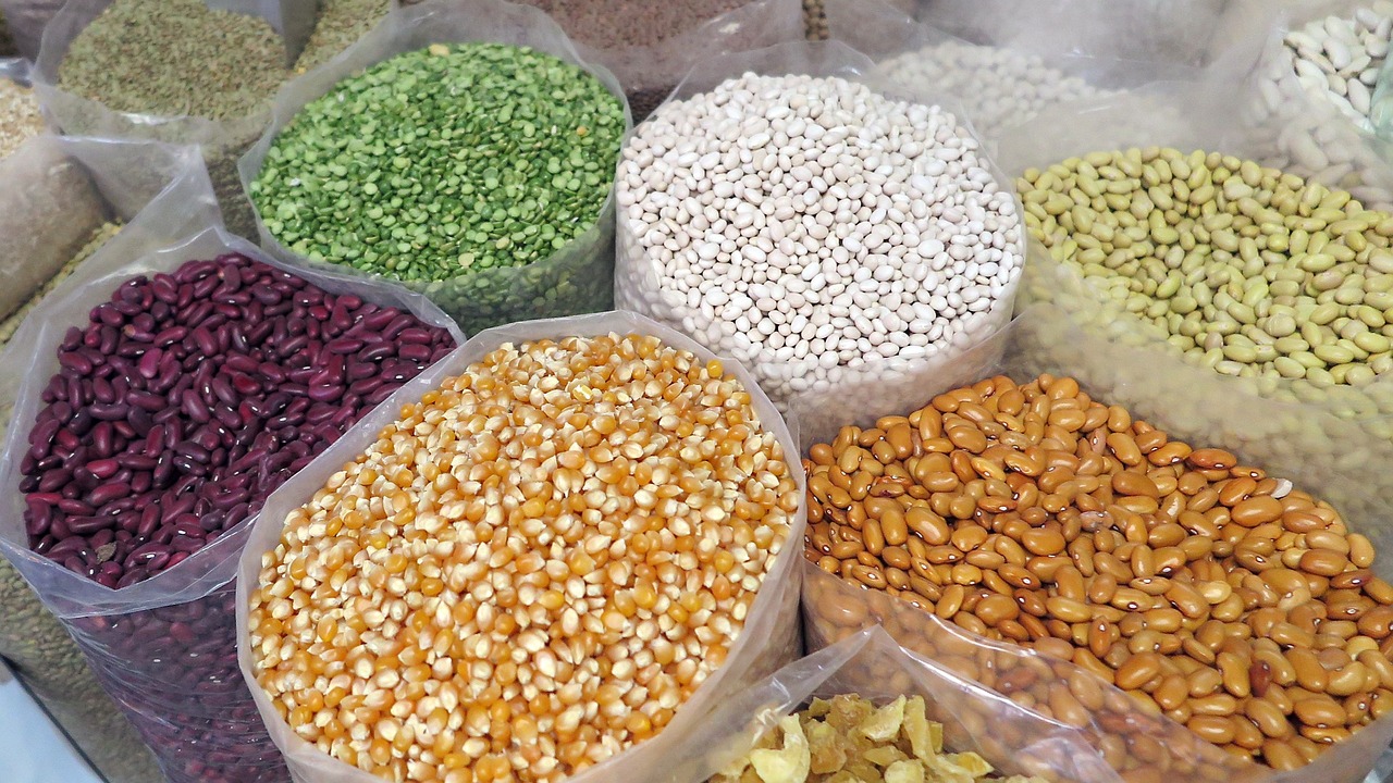 open bags of beans and corn sitting upright